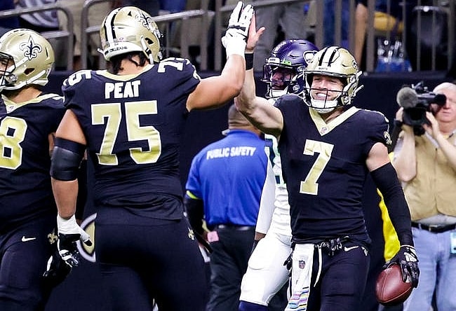 Oct 9, 2022; New Orleans, Louisiana, USA; New Orleans Saints tight end Taysom Hill (7) celebrates a touchdown against the Seattle Seahawks during the first half at Caesars Superdome. Mandatory Credit: Stephen Lew-USA TODAY Sports
