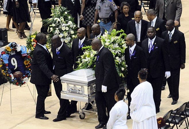 Courtesy of the USA Today: Members of the Baltimore Ravens raise McNair's casket at his funeral.