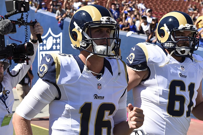 Rams quarterback Jared Goff leads the team on the field