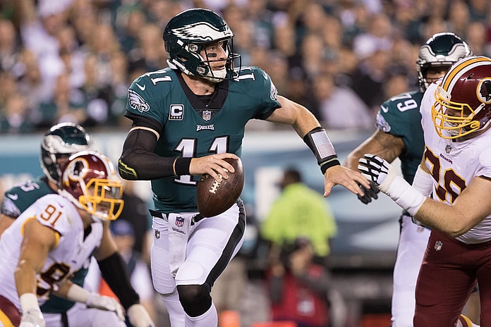 NFL Philadelphia Eagles quarterback Carson Wentz (11) runs out of the pocket past Washington Redskins defensive tackle Matthew Ioannidis (98) during the first quarter at Lincoln Financial Field.