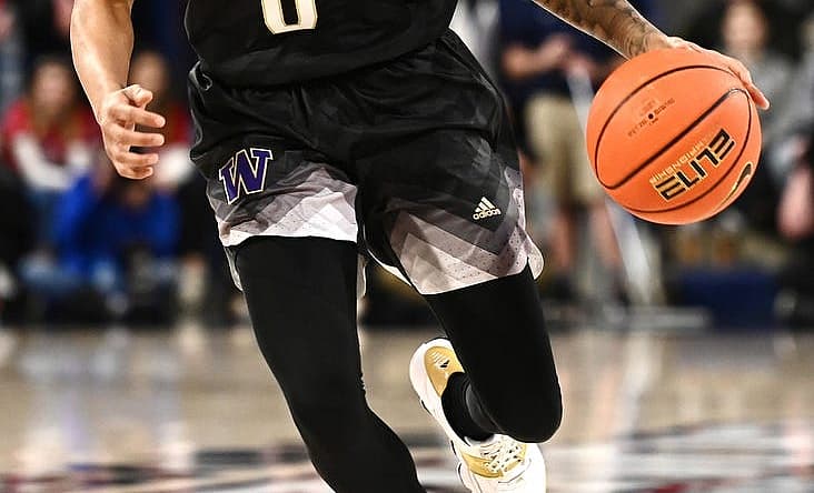 Dec 9, 2022; Spokane, Washington, USA; Washington Huskies guard Koren Johnson (0) brings the ball down court against the Gonzaga Bulldogs in the second half at McCarthey Athletic Center. Mandatory Credit: James Snook-USA TODAY Sports