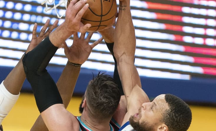 May 16, 2021; San Francisco, California, USA; Golden State Warriors guard Stephen Curry (30) blocks the shot attempt by Memphis Grizzlies center Jonas Valanciunas (17) during the first quarter at Chase Center. Mandatory Credit: Kyle Terada-USA TODAY Sports