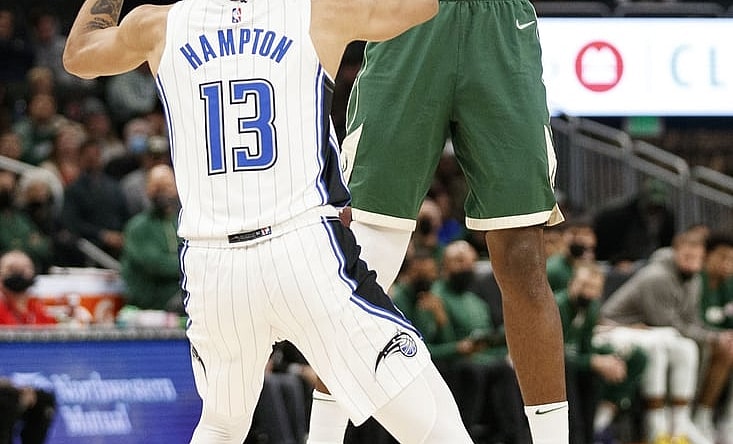 Nov 22, 2021; Milwaukee, Wisconsin, USA;  Milwaukee Bucks forward Khris Middleton (22) shoots over Orlando Magic guard R.J. Hampton (13) during the second quarter at Fiserv Forum. Mandatory Credit: Jeff Hanisch-USA TODAY Sports