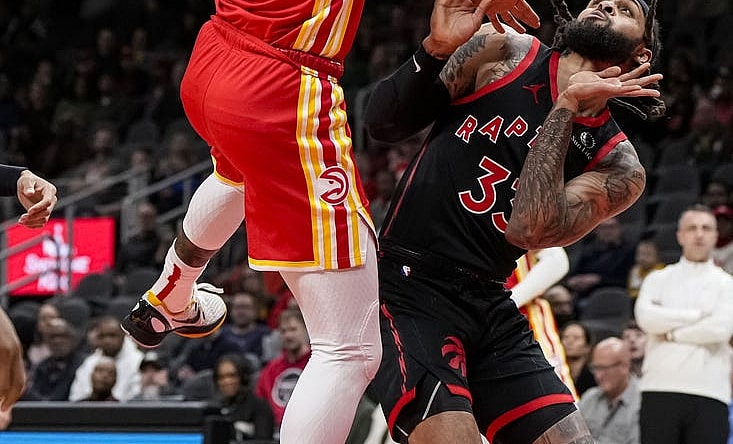 Jan 28, 2024; Atlanta, Georgia, USA; Atlanta Hawks forward Saddiq Bey (41) puts back a rebound over Toronto Raptors guard Gary Trent Jr. (33) during the first half at State Farm Arena. Mandatory Credit: Dale Zanine-USA TODAY Sports