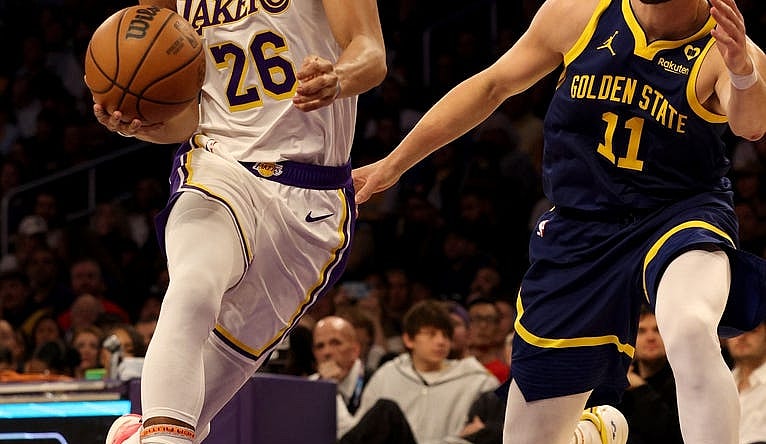 Mar 16, 2024; Los Angeles, California, USA; Los Angeles Lakers guard Spencer Dinwiddie (26) drives against Golden State Warriors guard Klay Thompson (11) during the second quarter at Crypto.com Arena. Mandatory Credit: Jason Parkhurst-USA TODAY Sports