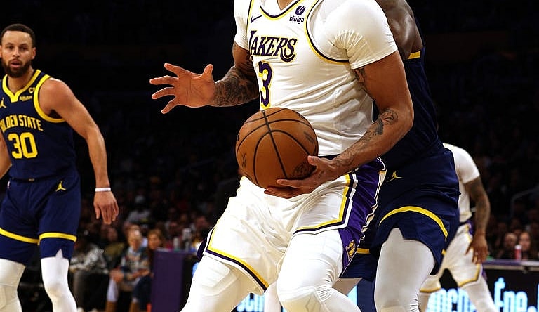 vMar 16, 2024; Los Angeles, California, USA; Los Angeles Lakers forward Anthony Davis (3) spins against Golden State Warriors forward Draymond Green (23) during the first quarter at Crypto.com Arena. Mandatory Credit: Jason Parkhurst-USA TODAY Sports