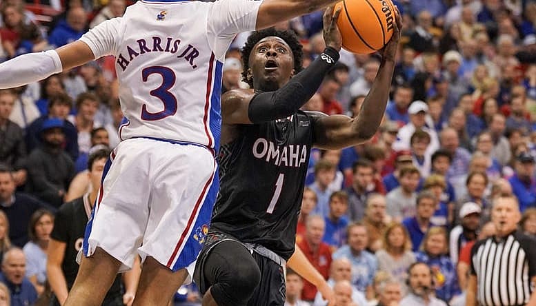 Nov 7, 2022; Lawrence, Kansas, USA; Omaha Mavericks guard JJ White (1) shoots as Kansas Jayhawk guard Dajuan Harris Jr. (3) defends during the first half at Allen Fieldhouse. Mandatory Credit: Denny Medley-USA TODAY Sports