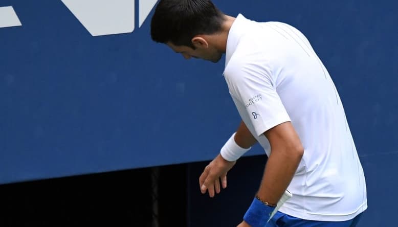 Sep 6, 2020; Flushing Meadows, New York, USA; Novak Djokovic of Serbia checks on a line judge after he unintentionally hit her with a tennis ball after losing a game to Pablo Carreno Busta of Spain (not pictured) on day seven of the 2020 U.S. Open tennis tournament at USTA Billie Jean King National Tennis Center. Mandatory Credit: Danielle Parhizkaran-USA TODAY Sports