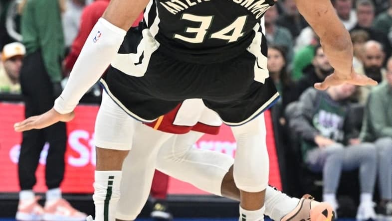 Apr 16, 2023; Milwaukee, Wisconsin, USA; Miami Heat center Bam Adebayo (13) drives against Milwaukee Bucks forward Giannis Antetokounmpo (34) in the first half during game one of the 2023 NBA Playoffs at Fiserv Forum. Mandatory Credit: Michael McLoone-USA TODAY Sports