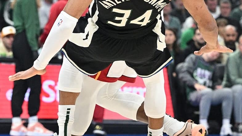 Apr 16, 2023; Milwaukee, Wisconsin, USA; Miami Heat center Bam Adebayo (13) drives against Milwaukee Bucks forward Giannis Antetokounmpo (34) in the first half during game one of the 2023 NBA Playoffs at Fiserv Forum. Mandatory Credit: Michael McLoone-USA TODAY Sports
