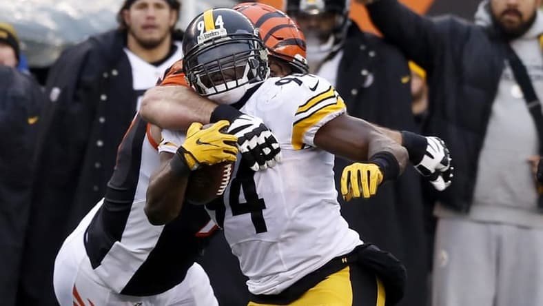 Dec 18, 2016; Cincinnati, OH, USA; Pittsburgh Steelers inside linebacker Lawrence Timmons (94) runs against Cincinnati Bengals tackle Andrew Whitworth (77) after intercepting a pass during the second half at Paul Brown Stadium. The Steelers won 24-20. Mandatory Credit: David Kohl-USA TODAY Sports
