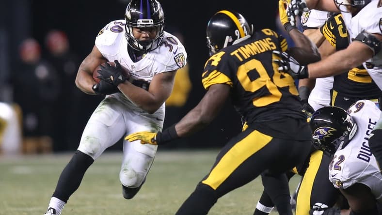 Dec 25, 2016; Pittsburgh, PA, USA; Baltimore Ravens running back Kenneth Dixon (30) rushes the ball against Pittsburgh Steelers inside linebacker Lawrence Timmons (94) during the fourth quarter at Heinz Field. The Steelers won 31-27. Mandatory Credit: Charles LeClaire-USA TODAY Sports