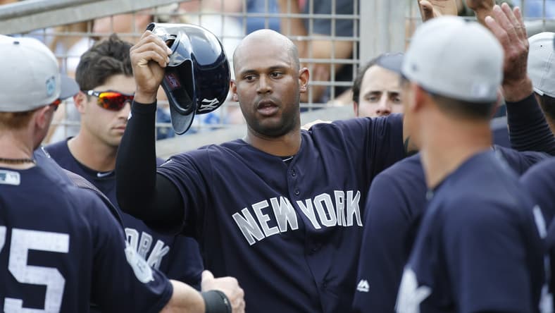Yankees right fielder Aaron Hicks is congratulated in the dugout