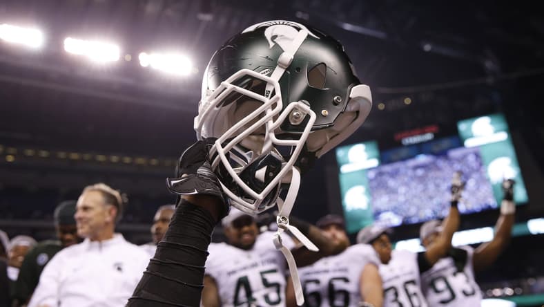 Dec 5, 2015; Indianapolis, IN, USA; A helmet is raised in celebration after the Michigan State Spartans defeated the Iowa Hawkeyes in the Big Ten Conference football championship game at Lucas Oil Stadium. Mandatory Credit: Brian Spurlock-USA TODAY Sports