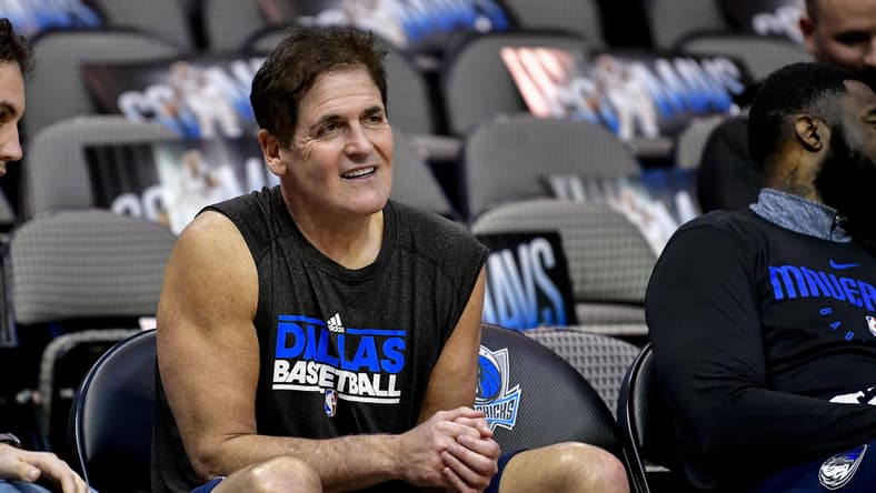 Dallas Mavericks owner Mark Cuban sits on the bench
