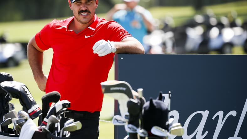 Brooks Koepka looks on with a mustache on his face