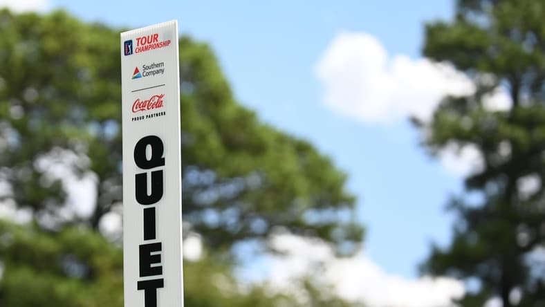Aug 22, 2019; Atlanta, GA, USA; A marshall holds up a quiet sign during the first round of the Tour Championship golf tournament at East Lake Golf Club. Mandatory Credit: Adam Hagy-USA TODAY Sports