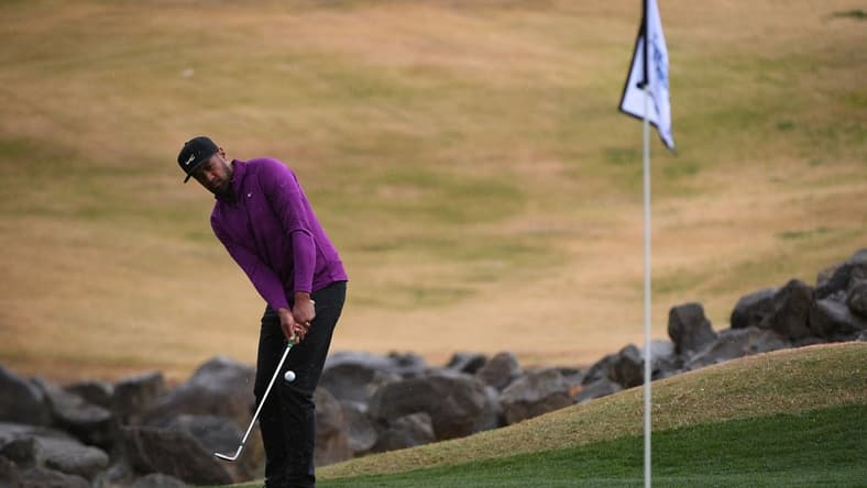 Jan 23, 2021; La Quinta, California, USA; Tony Finau chips onto the 18th green during the third round of The American Express golf tournament at PGA West Peter Dye Stadium Course. Mandatory Credit: Orlando Ramirez-USA TODAY Sports