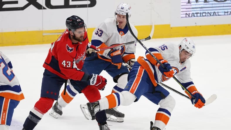 Jan 28, 2021; Washington, District of Columbia, USA; Washington Capitals right wing Tom Wilson (43) trips New York Islanders right wing Cal Clutterbuck (15) while battling for the puck in the first period at Capital One Arena. Mandatory Credit: Geoff Burke-USA TODAY Sports