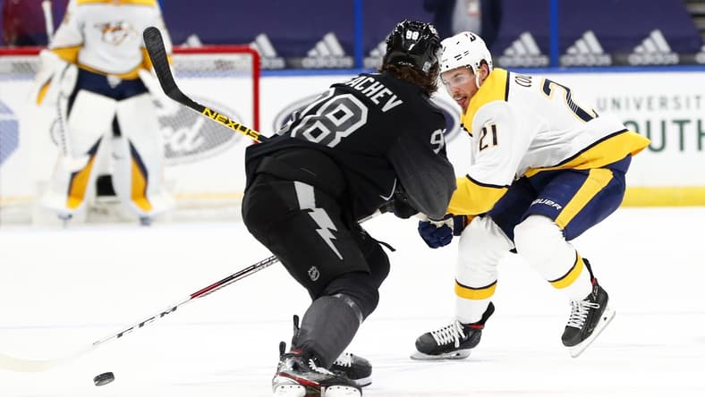 Jan 30, 2021; Tampa, Florida, USA; Nashville Predators center Nick Cousins (21) skates with the puck as Tampa Bay Lightning defenseman Mikhail Sergachev (98) defends during the second period at Amalie Arena. Mandatory Credit: Kim Klement-USA TODAY Sports