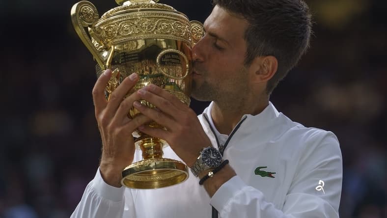 Jul 14, 2019; London, United Kingdom; Novak Djokovic (SRB) poses with the trophy after his mens final match against Roger Federer (SUI) on day 13 at the All England Lawn and Croquet Club. Mandatory Credit: Susan Mullane-USA TODAY Sports