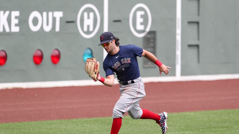 July 10, 2020; Boston, Massachusetts, United States; Boston Red Sox left fielder Andrew Benintendi (16) makes a catch during summer camp practices at Fenway Park. Mandatory Credit: Paul Rutherford-USA TODAY Sports