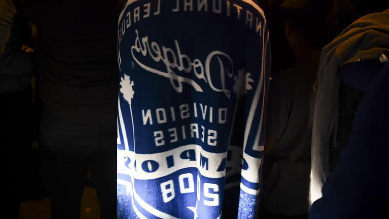 Oct 27, 2020; Los Angeles, California, USA; Fans on Whittier Blvd. in East Los Angeles celebrate the Los Angeles Dodgers winning their first World Series title since 1988. The Dodgers beat the Tampa Bay Rays in Game 6 to win.. Mandatory Credit: Harrison Hill-USA TODAY