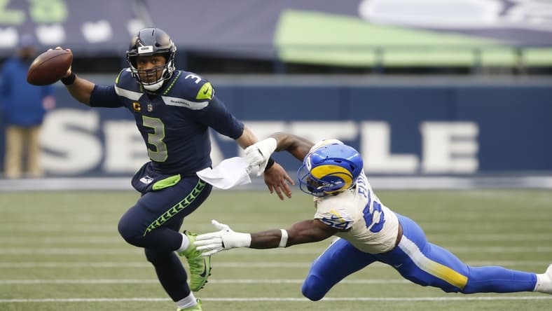 Jan 9, 2021; Seattle, Washington, USA; Seattle Seahawks quarterback Russell Wilson (3) avoids the tackle by Los Angeles Rams linebacker Leonard Floyd (54) during the third quarter at Lumen Field. Mandatory Credit: Joe Nicholson-USA TODAY Sports
