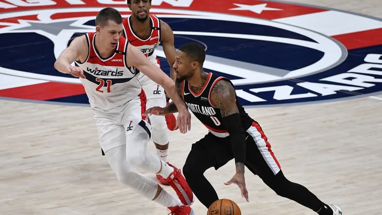 Feb 2, 2021; Washington, District of Columbia, USA; Portland Trail Blazers guard Damian Lillard (0) dribbles as Washington Wizards center Moritz Wagner (21) defends during the third quarter at Capital One Arena. Mandatory Credit: Brad Mills-USA TODAY Sports