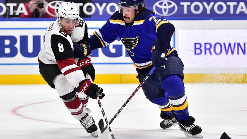 Feb 2, 2021; St. Louis, Missouri, USA; Arizona Coyotes center Nick Schmaltz (8) handles the puck as St. Louis Blues defenseman Justin Faulk (72) defends during the second period at Enterprise Center. Mandatory Credit: Jeff Curry-USA TODAY Sports