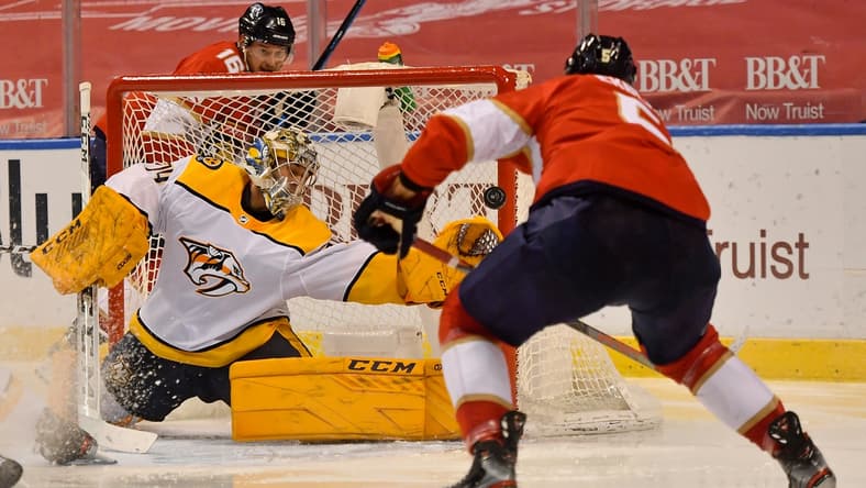 Feb 4, 2021; Sunrise, Florida, USA; Florida Panthers defenseman Aaron Ekblad (5) scores a goal past Nashville Predators goaltender Juuse Saros (74) during the second period at BB&T Center. Mandatory Credit: Jasen Vinlove-USA TODAY Sports