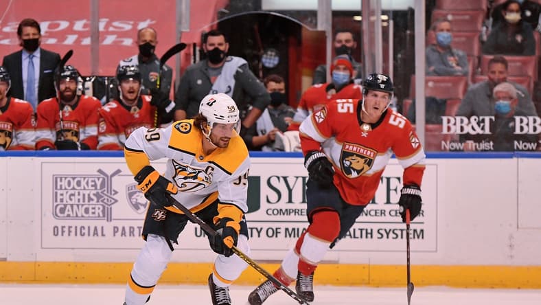 Feb 5, 2021; Sunrise, Florida, USA; Nashville Predators defenseman Roman Josi (59) skates with the puck past Florida Panthers center Noel Acciari (55) during the first period at BB&T Center. Mandatory Credit: Jasen Vinlove-USA TODAY Sports