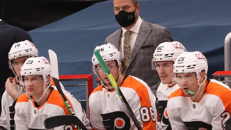 Feb 7, 2021; Washington, District of Columbia, USA; Philadelphia Flyers head coach Alain Vigneault (M) looks on from behind the bench against the Washington Capitals in the third period at Capital One Arena. Mandatory Credit: Geoff Burke-USA TODAY Sports