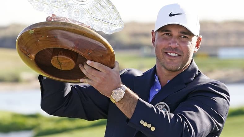 Feb 7, 2021; Scottsdale, Arizona, USA; Brooks Koepka poses with the trophy after winning the Waste Management Phoenix Open at TPC Scottsdale. Mandatory Credit: Rob Schumacher-USA TODAY Sports