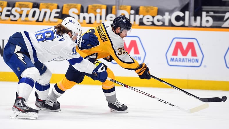 Feb 8, 2021; Nashville, Tennessee, USA; Nashville Predators right wing Viktor Arvidsson (33) attempts a shot with pressure from Tampa Bay Lightning defenseman Mikhail Sergachev (98) during the first period at Bridgestone Arena. Mandatory Credit: Christopher Hanewinckel-USA TODAY Sports