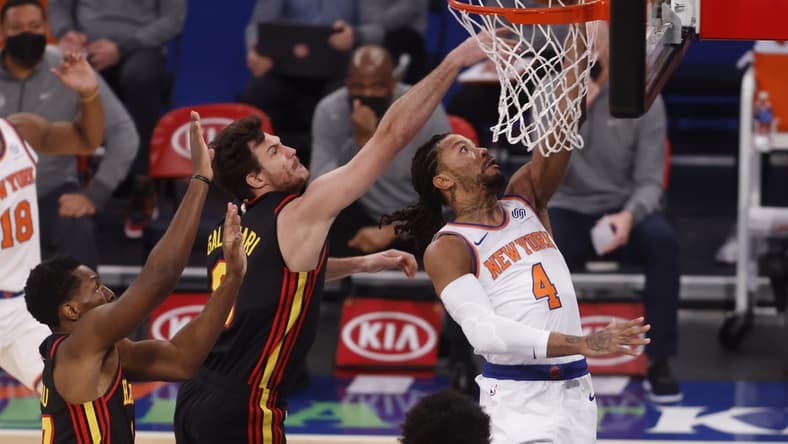 Feb 15, 2021; New York, New York, USA; New York Knicks' Derrick Rose (4) goes to the basket against Atlanta Hawks' Danilo Gallinari (8), of Italy, and Onyeka Okongwu (17) during the first quarter at Madison Square Garden. Mandatory Credit: Jason DeCrow/Pool Photo-USA TODAY Sports