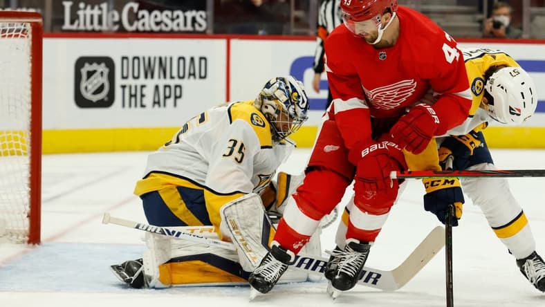 Feb 23, 2021; Detroit, Michigan, USA; Nashville Predators goaltender Pekka Rinne (35) makes the save ion Detroit Red Wings left wing Darren Helm (43) in the second period at Little Caesars Arena. Mandatory Credit: Rick Osentoski-USA TODAY Sports