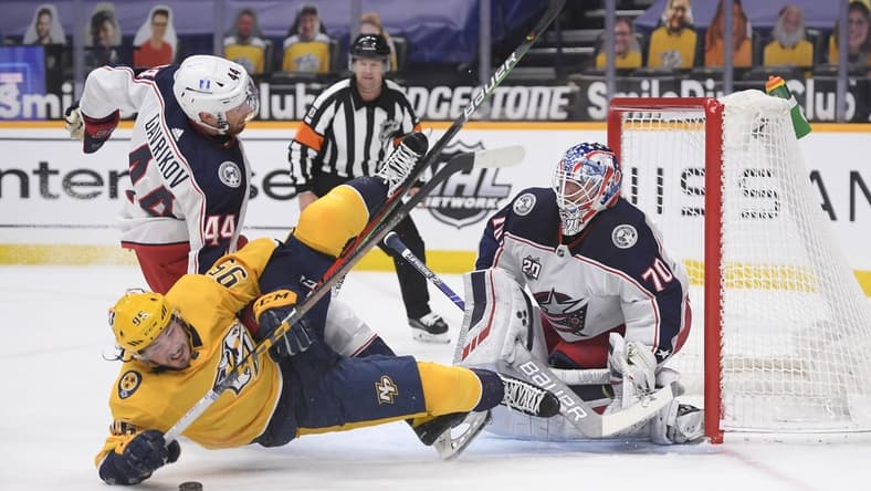 Feb 27, 2021; Nashville, Tennessee, USA; Columbus Blue Jackets goaltender Joonas Korpisalo (70) blocks a shot by Nashville Predators center Matt Duchene (95) during the first period at Bridgestone Arena. Mandatory Credit: Steve Roberts-USA TODAY Sports