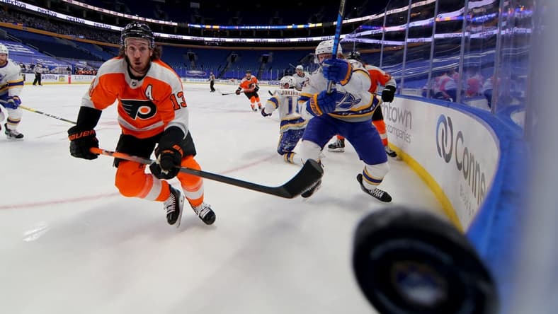 Feb 28, 2021; Buffalo, New York, USA; Philadelphia Flyers center Kevin Hayes (13) watches the puck as it goes along the glass during the first period against the Buffalo Sabres at KeyBank Center. Mandatory Credit: Timothy T. Ludwig-USA TODAY Sports