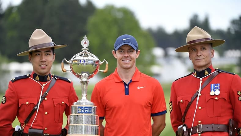 Jun 9, 2019; Hamilton, Ontario, CAN; Rory McIlroy poses with the trophy and two members of the Royal Canadian Mounted Police after winning the 2019 RBC Canadian Open golf tournament at Hamilton Golf & Country Club. Mandatory Credit: Eric Bolte-USA TODAY Sports