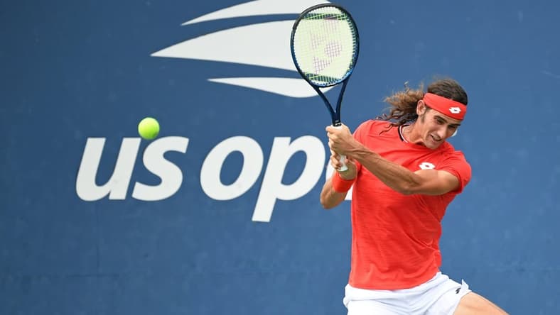 Sep 2, 2020; Flushing Meadows, New York, USA; LloydHarris of South Africa hits a backhand against David Goffin of Belgium (not pictured) on day three of the 2020 U.S. Open tennis tournament at USTA Billie Jean King National Tennis Center. Mandatory Credit: Danielle Parhizkaran-USA TODAY Sports