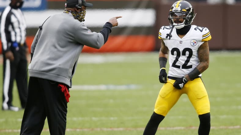 Jan 3, 2021; Cleveland, Ohio, USA; Pittsburgh Steelers head coach Mike Tomlin talks with cornerback Steven Nelson (22) during the first quarter against the Cleveland Browns at FirstEnergy Stadium. Mandatory Credit: Scott Galvin-USA TODAY Sports