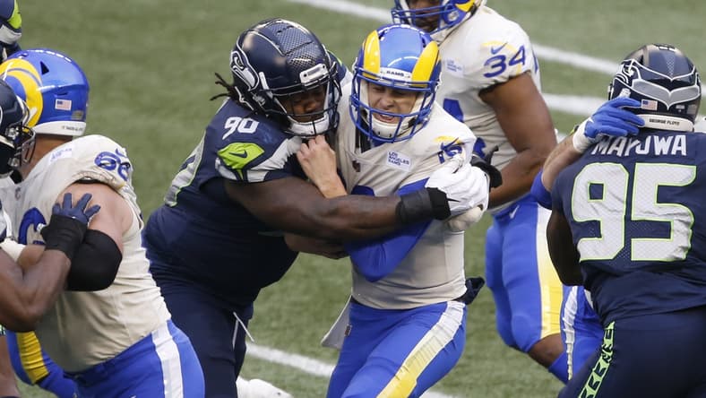 Jan 9, 2021; Seattle, Washington, USA; Seattle Seahawks defensive tackle Jarran Reed (90) sacks Los Angeles Rams quarterback Jared Goff (16) during the third quarter at Lumen Field. Mandatory Credit: Joe Nicholson-USA TODAY Sports