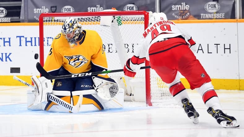 Jan 18, 2021; Nashville, Tennessee, USA; Nashville Predators goaltender Pekka Rinne (35) makes a save on a shot by Carolina Hurricanes left wing Jordan Martinook (48) during the second period at Bridgestone Arena. Mandatory Credit: Christopher Hanewinckel-USA TODAY Sports