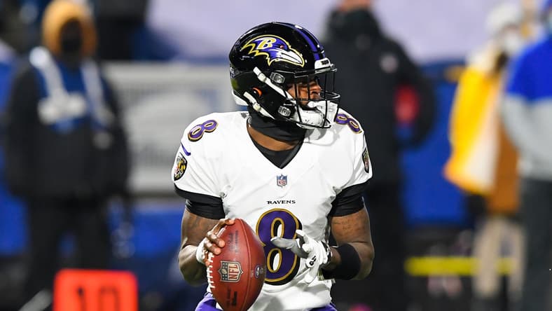 Jan 16, 2021; Orchard Park, New York, USA; Baltimore Ravens quarterback Lamar Jackson (8) drops back to pass against the Buffalo Bills during the first quarter of an AFC Divisional Round game at Bills Stadium. Mandatory Credit: Rich Barnes-USA TODAY Sports