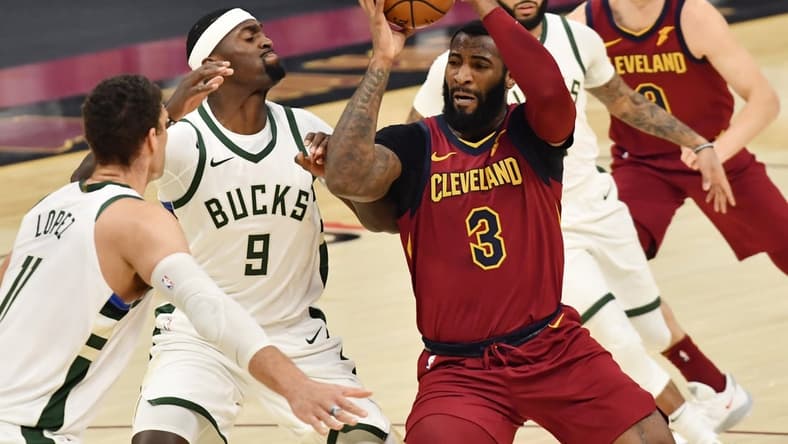 Feb 5, 2021; Cleveland, Ohio, USA; Cleveland Cavaliers center Andre Drummond (3) drives to the basket against Milwaukee Bucks center Bobby Portis (9) and center Brook Lopez (11) during the first quarter at Rocket Mortgage FieldHouse. Mandatory Credit: Ken Blaze-USA TODAY Sports