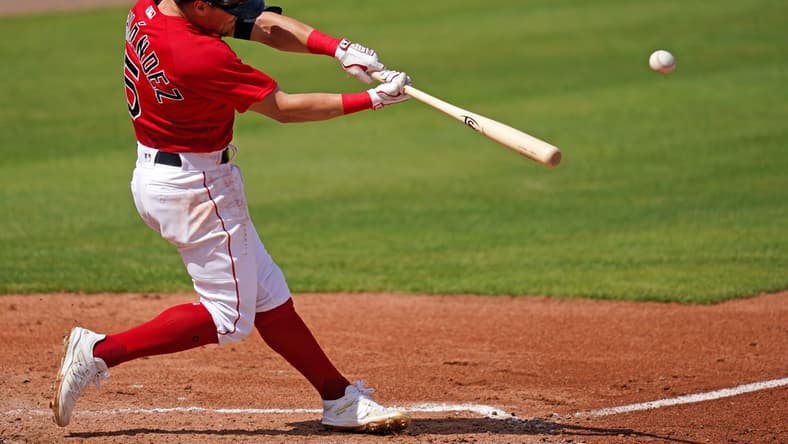 Mar 2, 2021; Fort Myers, Florida, USA; Boston Red Sox short stop Enrique Hernandez (5) connects for a solo homerun in the 3rd inning of the spring training game against the Tampa Bay Rays at JetBlue Park at Fenway South. Mandatory Credit: Jasen Vinlove-USA TODAY Sports