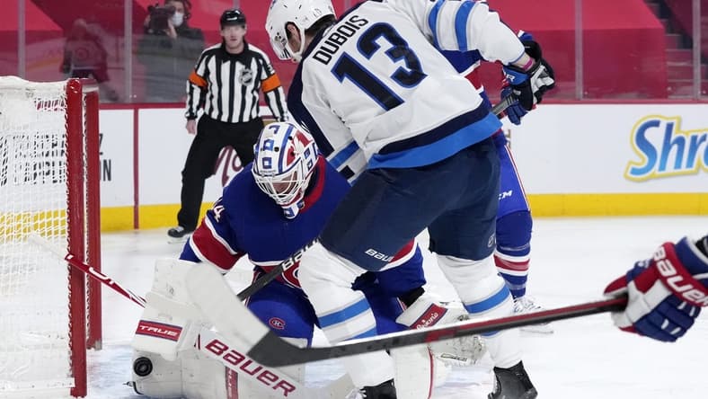 Mar 4, 2021; Montreal, Quebec, CAN; Montreal Canadiens goalie Jake Allen (34) stops a shot by Winnipeg Jets forward Pierre-Luc Dubois (13) during the first period at the Bell Centre. Mandatory Credit: Eric Bolte-USA TODAY Sports