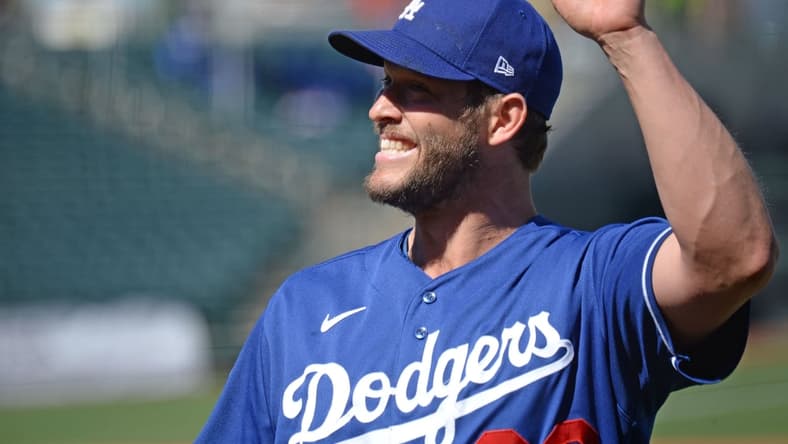 Mar 5, 2021; Surprise, Arizona, USA; Los Angeles Dodgers starting pitcher Clayton Kershaw (22) waves to fans during the second inning of a spring training game against the Kansas City Royals at Surprise Stadium. Mandatory Credit: Joe Camporeale-USA TODAY Sports