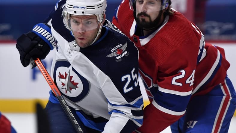 Mar 6, 2021; Montreal, Quebec, CAN; Winnipeg Jets forward Paul Stasny (25) and Montreal Canadiens forward Phillip Danault (24) battle for position during the first period at the Bell Centre. Mandatory Credit: Eric Bolte-USA TODAY Sports